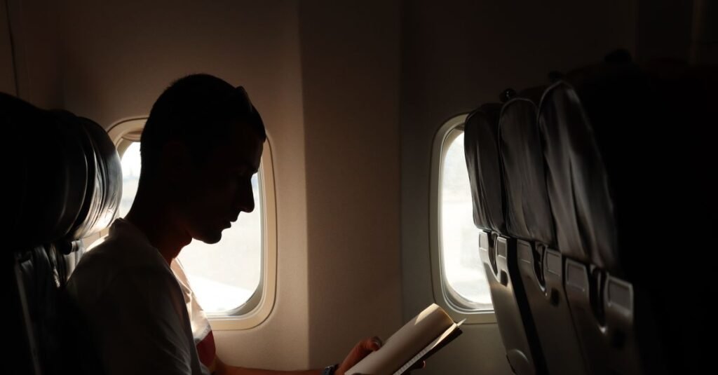 A passenger reading in an aircraft seat
