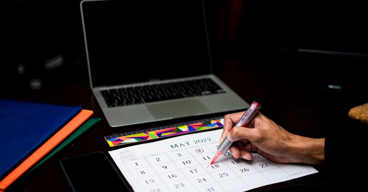 A calendar of dates open on a laptop
