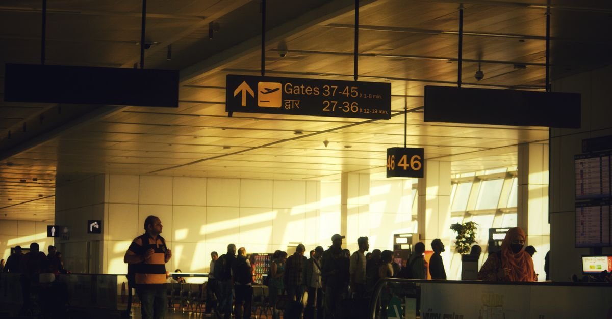 Passengers queuing in boarding groups at an airport departure gate