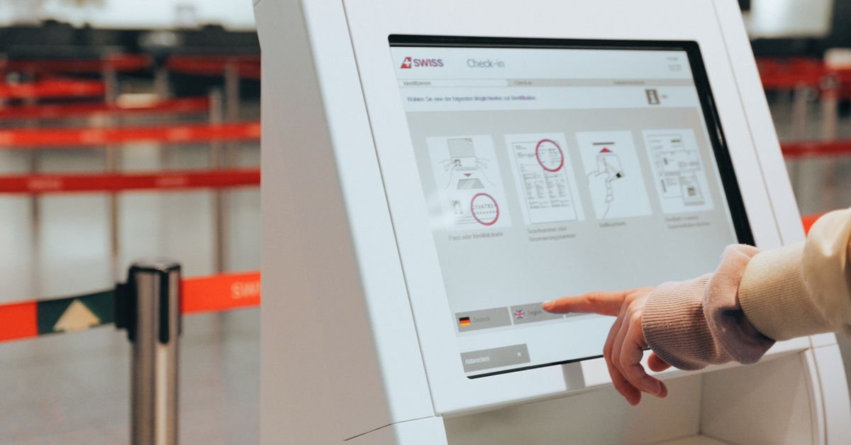 A traveller using a self-service check-in kiosk