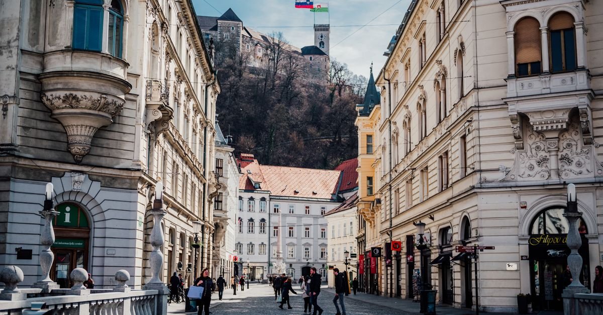 Visitors walking through a European city square