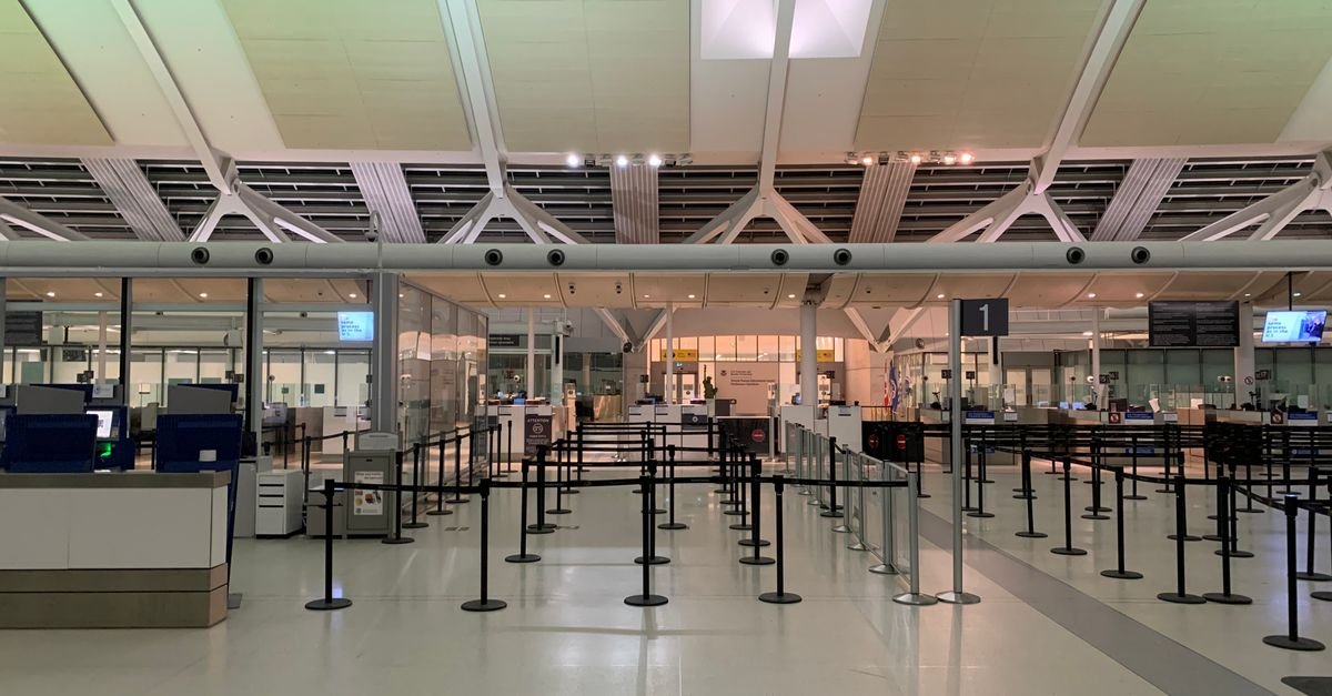A gate agent at a boarding desk