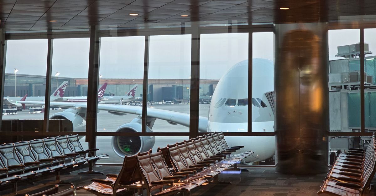 Seats beside a window in an airport departure lounge