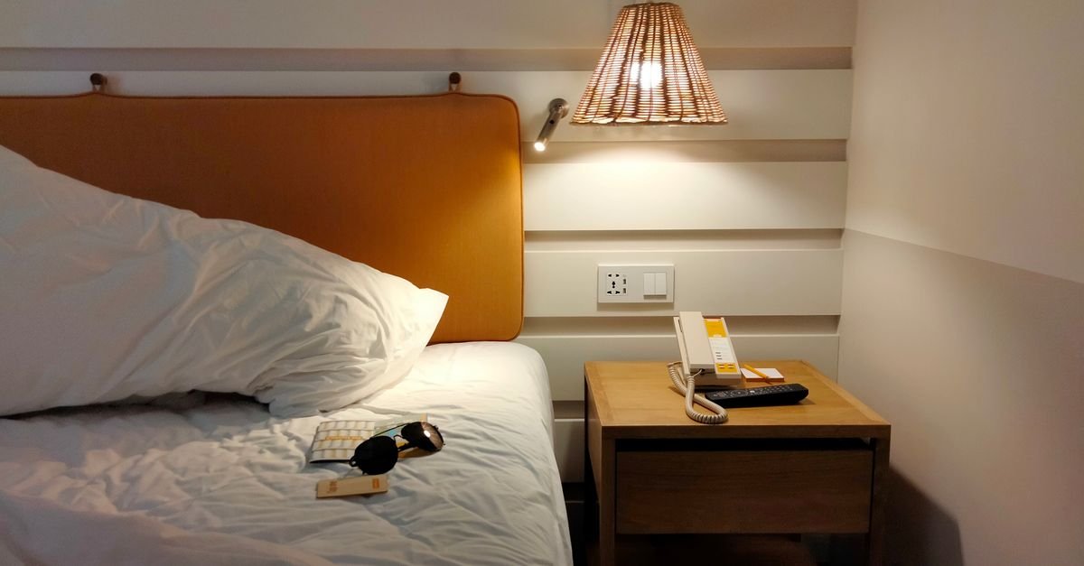 A made bed in a modern hotel room
