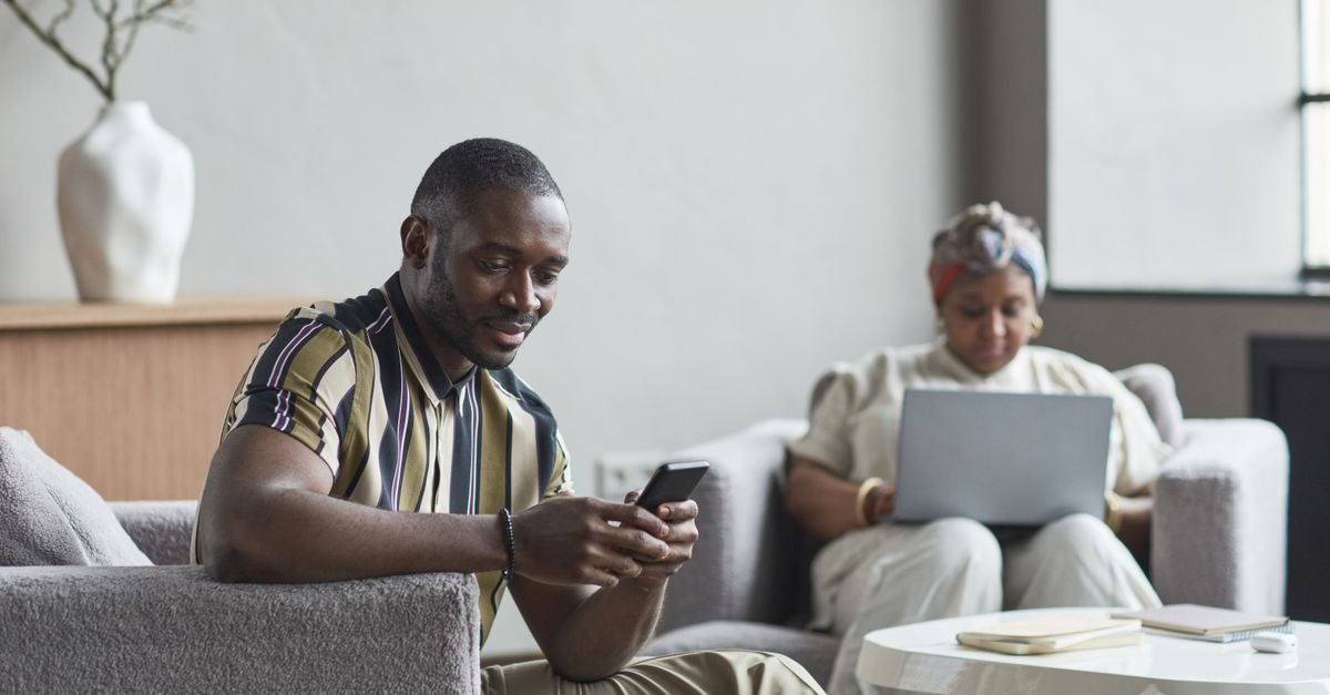 A traveller checking a phone in a hotel lobby
