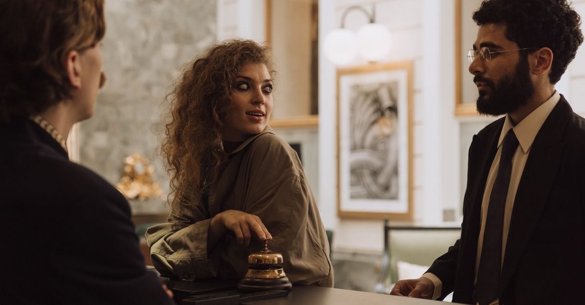 A guest being greeted at a hotel front desk