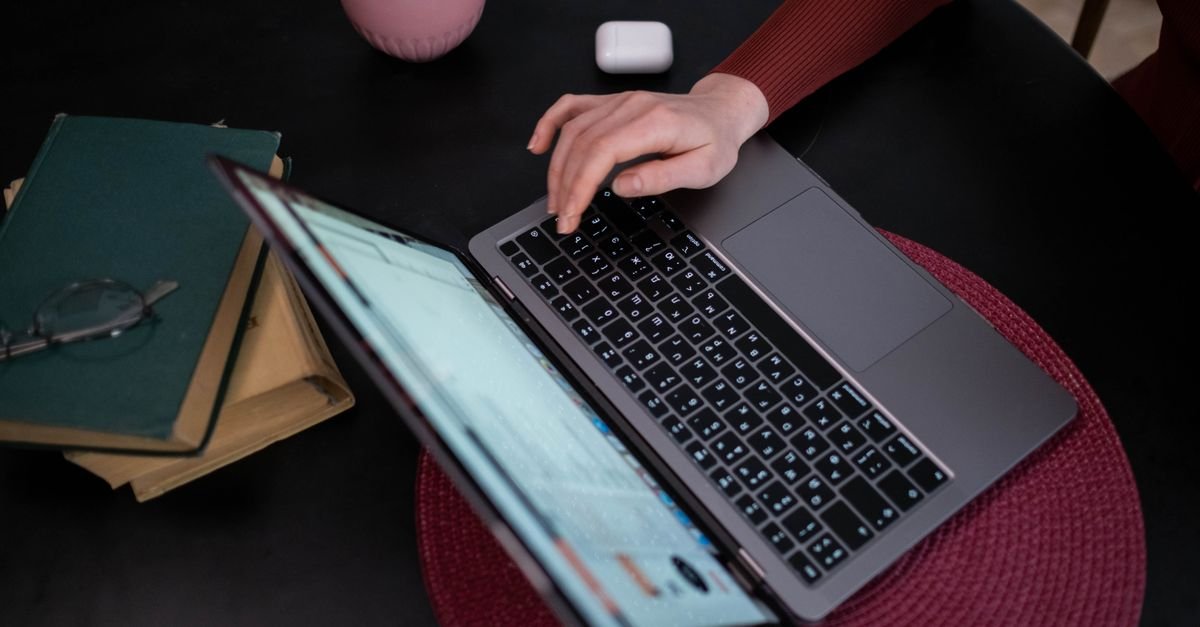A traveller booking a hotel room on a laptop