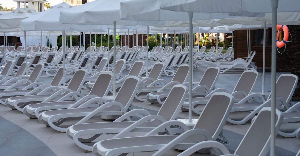 Loungers beside a resort swimming pool