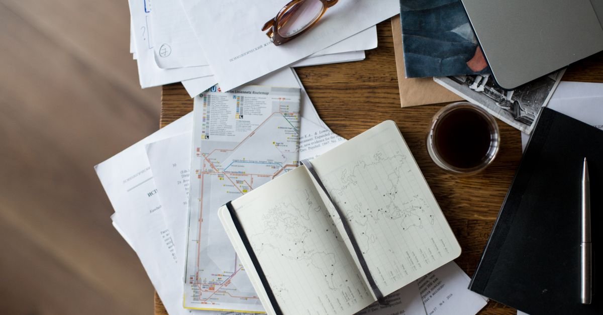 Travel planning materials spread across a desk