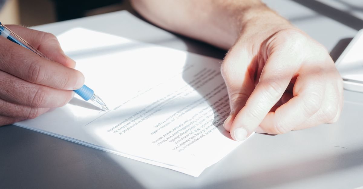 An insurance document and pen on a desk